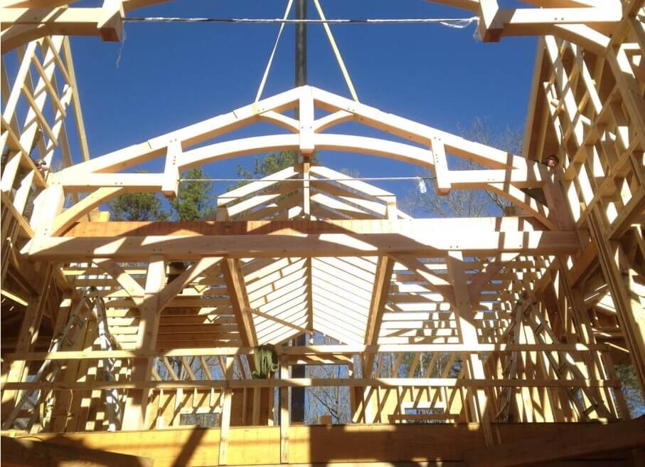 timber frame raising - placing trusses with crane