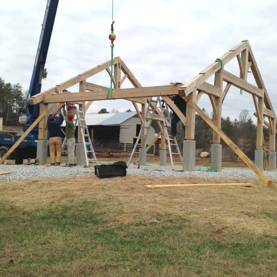 connecting girt being placed on timber frame pavilion