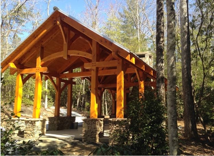 timber framed pavilion next to creek