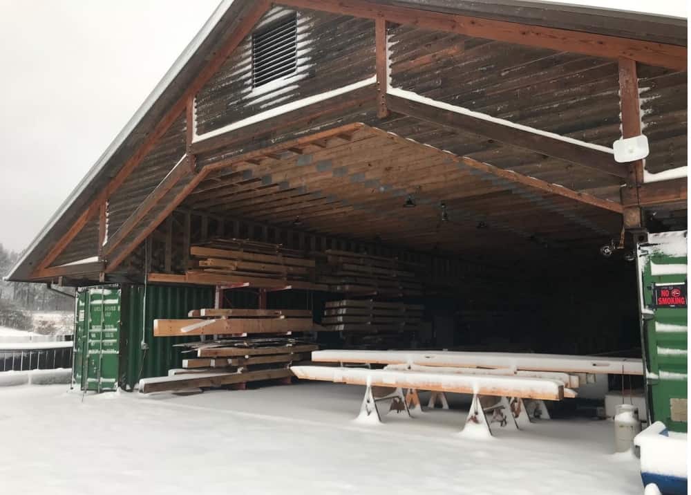 timber frame shop in snow