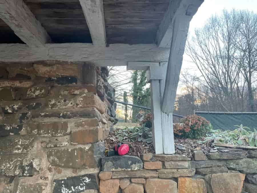 post rests on rock wall